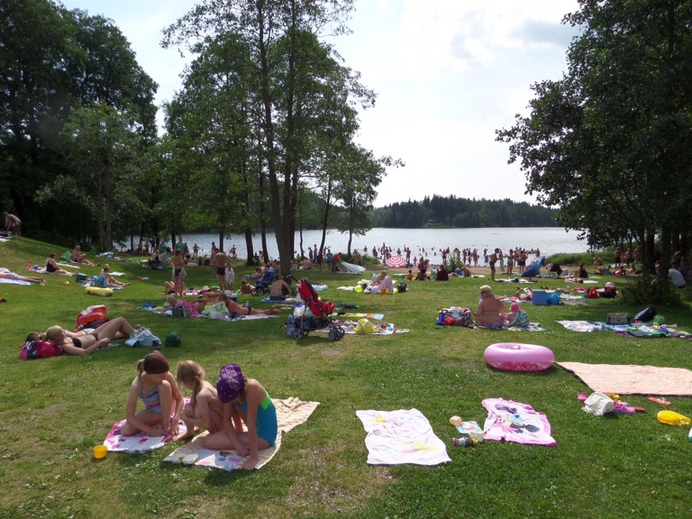 Sunbathing beside the lake in Luukki, Espoo, Finland